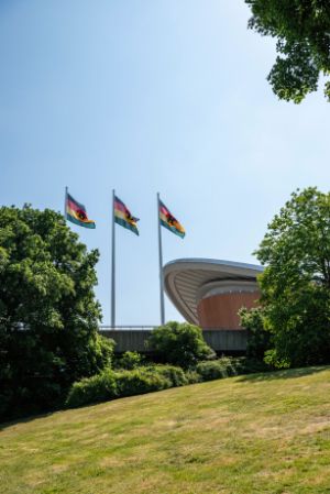 Olu Oguibe,&nbsp;DDR: Decarbonize, Decolonize, Rehabilitate (2023), textile work, 3 flags, 4.5 x 7 m each. Courtesy of the artist. Installation view of the exhibition, Haus der Kulturen der Welt (HKW), 2023.&nbsp; &nbsp; &nbsp; &nbsp; &nbsp; &nbsp; &nbsp; &nbsp; &nbsp; &nbsp; &nbsp;&nbsp;

