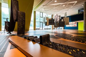 Jasmine Thomas-Girvan, The Healing Stream (2022), installation, paper, graphite, acrylic and wood, L: 350 cm, Courtesy of the artist.&nbsp;Antonio Jose Guzman &amp; Iva Jankovic,&nbsp;Transatlantic Stargate (2023), indigo dyed textiles, 5 x 5 m, Courtesy of the artists. Installation view of the exhibition, Haus der Kulturen der Welt (HKW), 2023.&nbsp;
