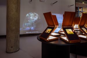 Sim Chi Yin, The Mountain That Hid (2022), 2-channel-video, sound, 5&lsquo; 56&ldquo; and&nbsp;The Suitcase Is A Little Bit Rotten (2023), UV print on glass, light box, replica vintage retouching stand, dimensions vary
